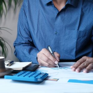 a person writing on a piece of paper