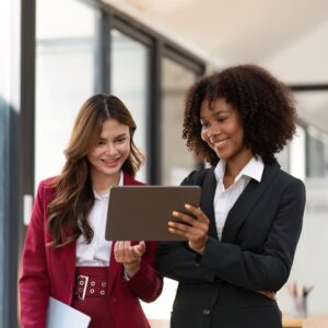 two business women looking at tablet